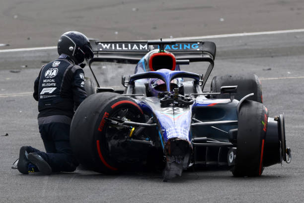 An FIA Medical Delegate checks on Alexander Albon of Thailand driving the Williams FW44 Mercedes after he runs off the track after a crash at the...