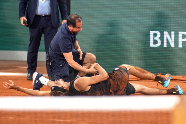 An injured Alexander Zverev of Germany after falling resulting in his retirement during his match against Rafael Nadal of Spain during the Singles...