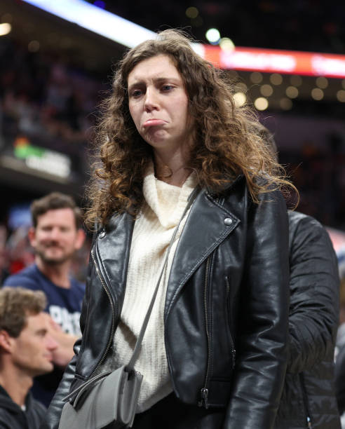 An unidentified fan is removed from the arena following a disturbance involving LeBron James of the Los Angeles Lakers during the game against the...