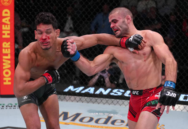 Andre Fialho of Portugal punches Miguel Baeza in a welterweight fight during the UFC Fight Night event at UFC APEX on April 16, 2022 in Las Vegas,...