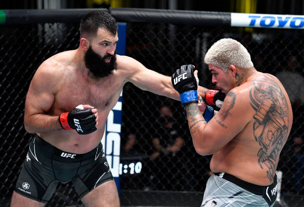Andrei Arlovski of Belarus punches Carlos Felipe of Brazil in a heavyweight fight during the UFC Fight Night event at UFC APEX on October 16, 2021 in...