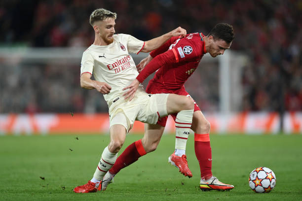 Andrew Robertson of Liverpool is challenged by Alexis Saelemaekers of AC Milan during the UEFA Champions League group B match between Liverpool FC...