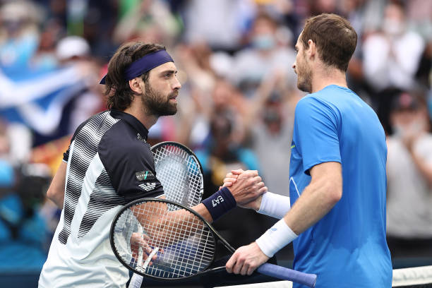 Andy Murray of Great Britain shakes hands with Nikoloz Basilashvili of Georgia after winning his first round singles match during day two of the 2022...