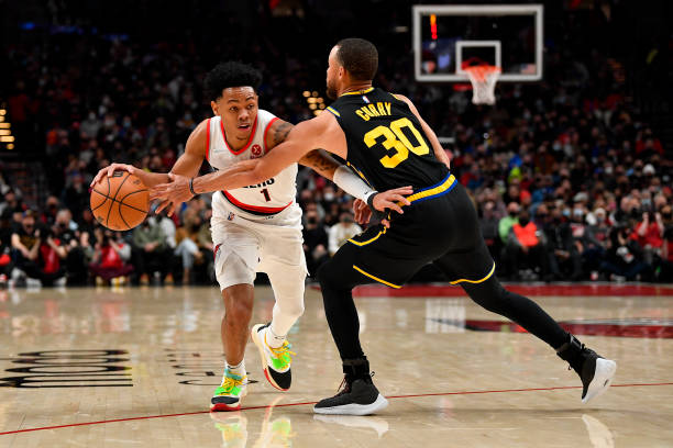 Anfernee Simons of the Portland Trail Blazers drives to the basket against Stephen Curry of the Golden State Warriors during the second quarter at...