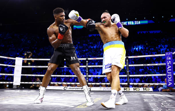 Anthony Joshua evades a punch from Oleksandr Usyk during their World Heavyweight Championship fight during the Rage on the Red Sea Heavyweight Title...