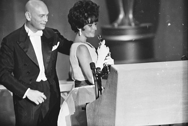 April 17, 1961 - Santa Monica, California: Actress Elizabeth Taylor holds her Oscar, the first she has ever won, with presenter Yul Brynner standing...