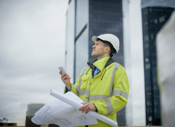 architect on high rise construction site with blueprints - construction wifi stock pictures, royalty-free photos & images