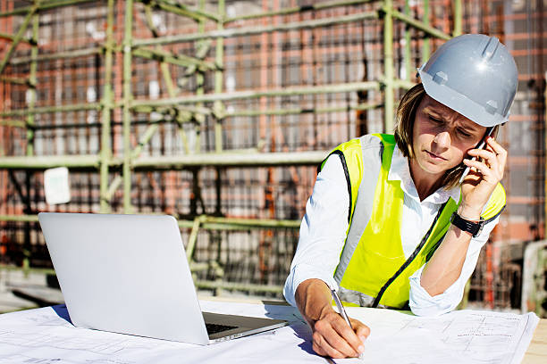 architect using mobile phone while working at site picture