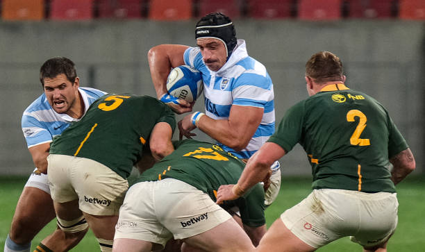 Argentinas lock Tomas Lavanini (C) is tackled by South Africa's prop Steven Kitshoff (down) during the Rugby Championship international rugby union Test match between South Africa and Argentina at The Nelson Mandela Bay Stadium in Port Elizabeth on August 21, 2021. (Photo by Michael Sheehan / AFP) (Photo by MICHAEL SHEEHAN/AFP via Getty Images)