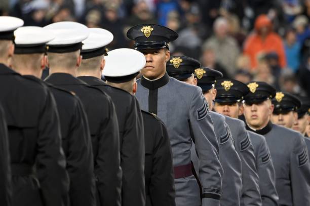 Army and Navy members meet half way as US President Donald Trump attends the Army-Navy football game in Philadelphia, Pennsylvania on December 14,...