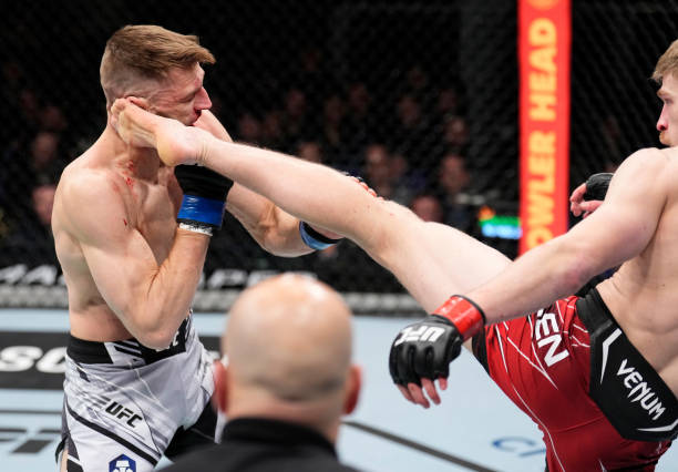 Arnold Allen of England kicks Dan Hooker of New Zealand in a featherweight fight during the UFC Fight Night event at O2 Arena on March 19, 2022 in...