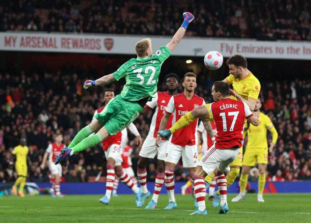 Arsenal's English goalkeeper Aaron Ramsdale saves the ball from the path of Liverpool's Portuguese striker Diogo Jota during the English Premier...