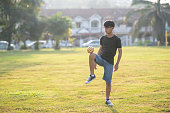 asian chinese teenage boy playing sepak takraw in a sunny day