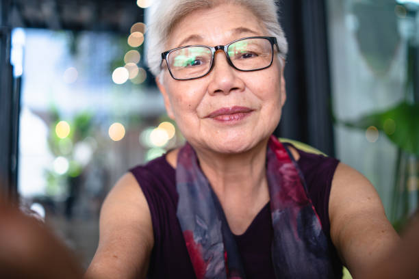 asian senior lady taking her selfie. - asian old woman stock pictures, royalty-free photos & images