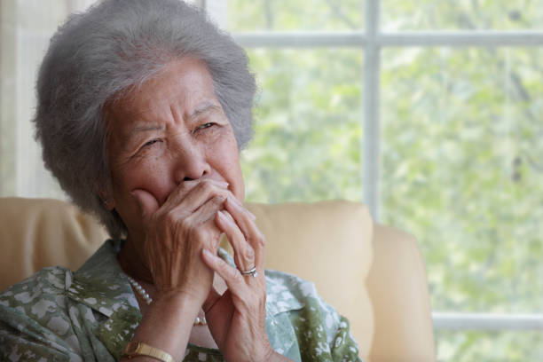 asian woman covering mouth with hand - crying old asian woman stock pictures, royalty-free photos & images