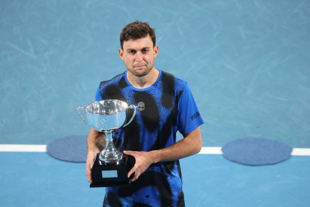 Aslan Karatsev of Russia celebrates with the trophy after winning against Andy Murray of Britain in the men's singles final match at the Sydney...