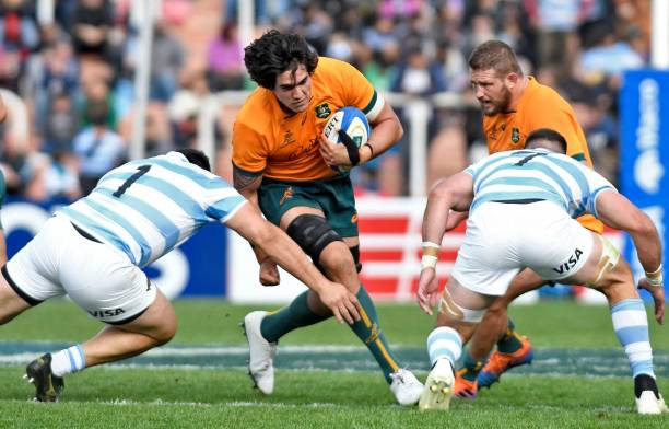 Australia's Wallabies Darcy Swain (C) is tackled by Argentina's Los Pumas Nahuel Tetaz Chaparro (L) and Marcos Kremer (R) during their Rugby Championship 2022 test match at the Malvinas Argentinas stadium in Mendoza, Argentina, on August 6, 2022. (Photo by Andres Larrovere / AFP) (Photo by ANDRES LARROVERE/AFP via Getty Images)