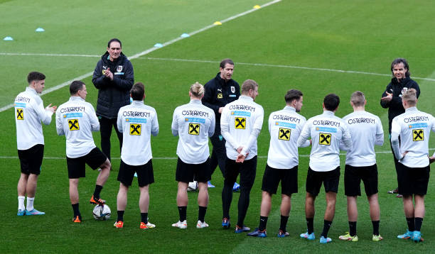 Austria head coach Franco Foda talks to his players during a training session at the Cardiff City Stadium. Picture date: Wednesday March 23, 2022.