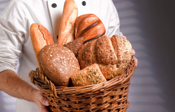 baker carrying basket of freshly baked bread picture