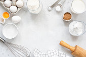 Baking and cooking ingredients on bright grey background