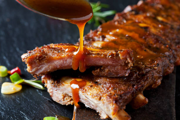 barbecue sauce dripping on marinated and grilled spare ribs picture