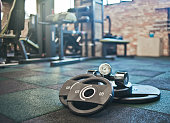 Barbell, dumbbells lie on the floor against the background of the gym. Free weight training. Functional powerful training