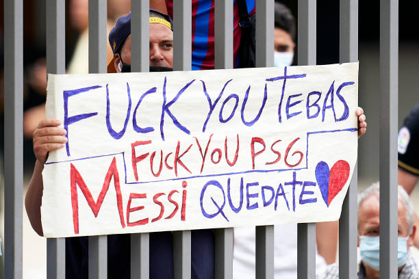 Barcelona supporters hold up signs outside the FC Barcelona press conference after the FC Barcelona president Joan Laporta's press conference after...