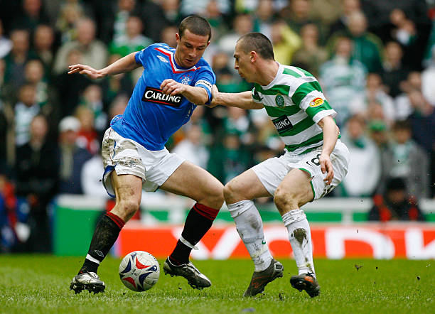 barry-ferguson-of-rangers-is-tackled-by-scott-brown-of-celtic-during-picture-id80425407