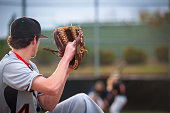 Baseball Series: Pitcher in motion, batter, catcher and umpire defocused