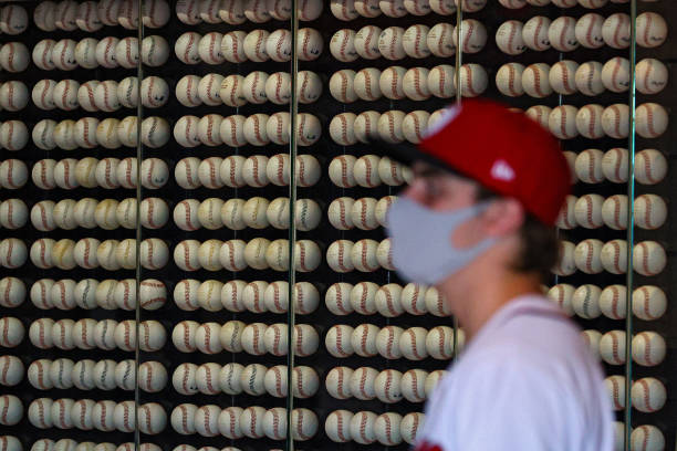 Baseballs are seen as a fan wears a protective face covering due to the coronavirus before the Washington Nationals 2021 Opening Day against the...