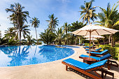Beautiful tropical beach front hotel resort with swimming pool, sunshine