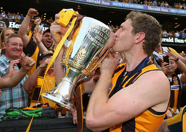 Ben McEvoy of the Hawks celebrates with the trophy after winning the 2015 AFL Grand Final match between the Hawthorn Hawks and the West Coast Eagles...