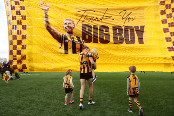 Ben McEvoy of the Hawks walks towards the banner with his children during the round 23 AFL match between the Hawthorn Hawks and the Western Bulldogs...