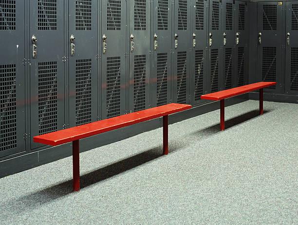 benches in empty locker room - locker room stock pictures, royalty-free photos & images