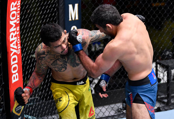 Beneil Dariush of Iran punches Diego Ferreira of Brazil in their lightweight fight during the UFC Fight Night event at UFC APEX on February 06, 2021...