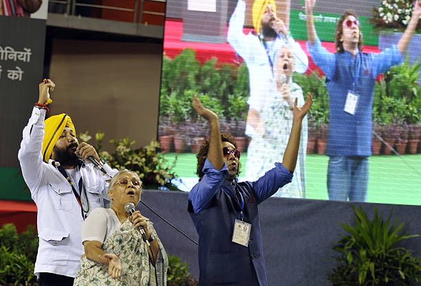 Bhangra pop singer Daler Mehndi singing a song alongwith Delhi Chief Minister Sheila Dikshit during a function to confer ownership rights to the...