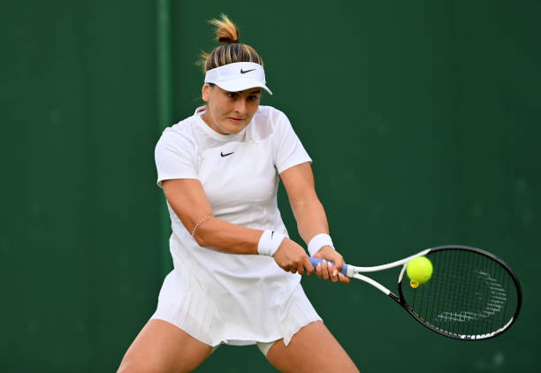 Bianca Andreescu of Canada plays a backhand against Emina Bektas of The United States during their Women's Singles First Round Match on day two of...