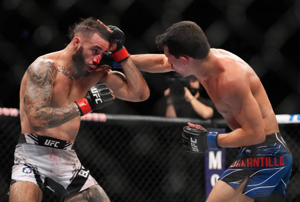 Billy Quarantillo punches Shane Burgos in their featherweight fight during the UFC 268 event at Madison Square Garden on November 06, 2021 in New...