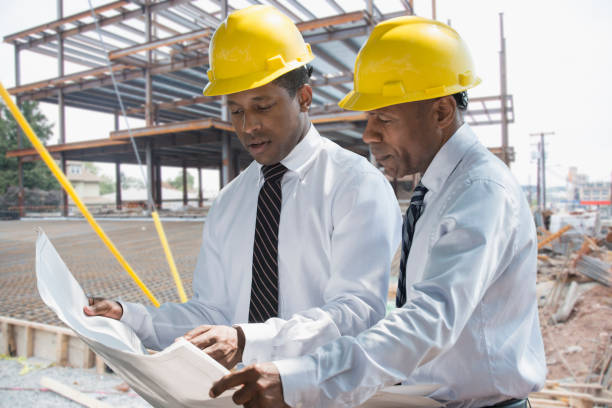 black businessman reading blueprints at construction site picture