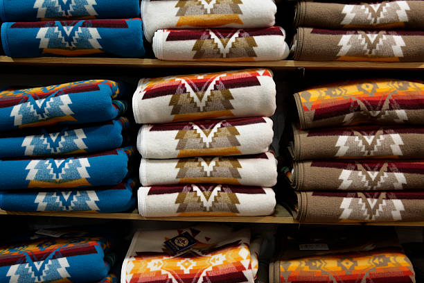 blankets displayed for sale sit in folded stacks at the pendleton picture