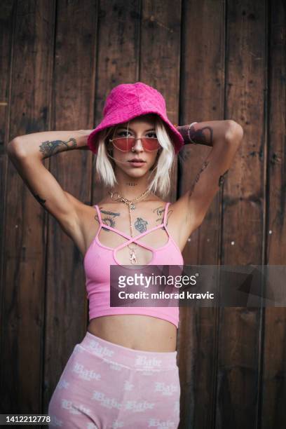 blonde woman posing with tattoos all