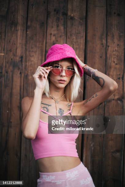 blonde woman posing with tattoos all
