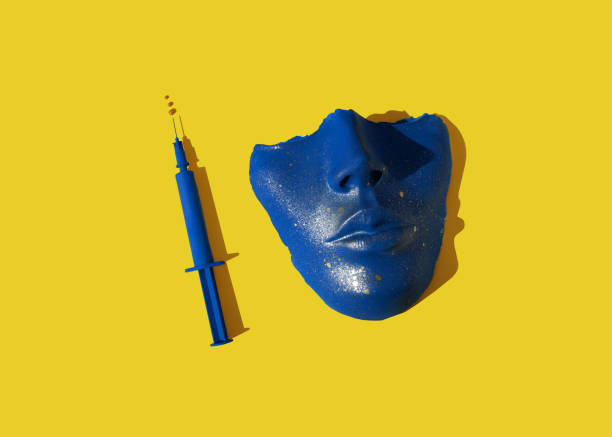 blue colored syringe and face mask on the yellow background picture