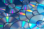 Blue tinted image of stacked CD/DVD texture background