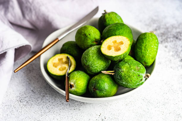bowl of ripe organic feijoa fruits - feijoa stock pictures, royalty-free photos & images