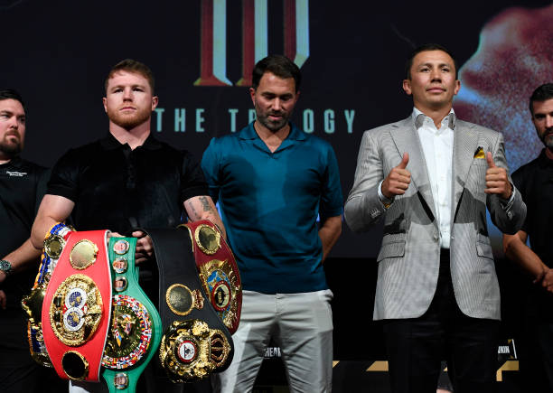 Boxer Canelo Alvarez and Gennady Golovkin pose, with boxing promotor Eddie Hearn during a news conference on June 24, 2022 in Hollywood, California....