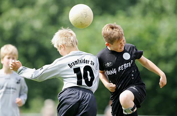 Boys from the 9-11 year old age group go up for a header during the German Football Association's E-Youth children's soccer tournament on June 23,...