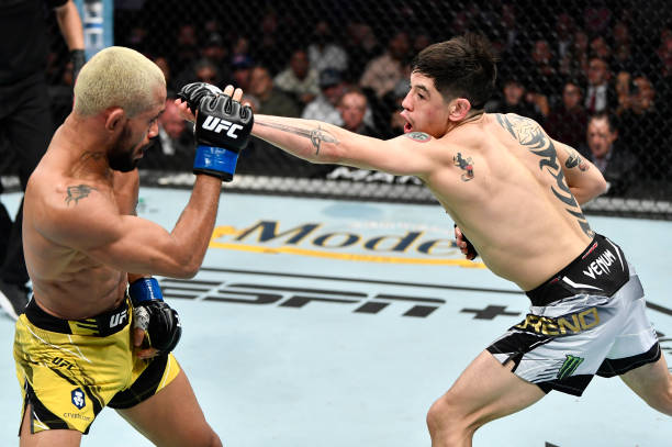 Brandon Moreno of Mexico punches Deiveson Figueiredo of Brazil in their UFC flyweight championship fight during the UFC 270 event at Honda Center on...