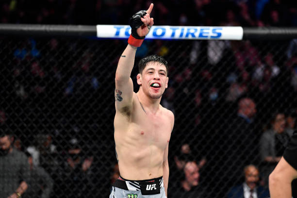 Brandon Moreno of Mexico reacts after the conclusion of his five-round battle against Deiveson Figueiredo of Brazil in their UFC flyweight...