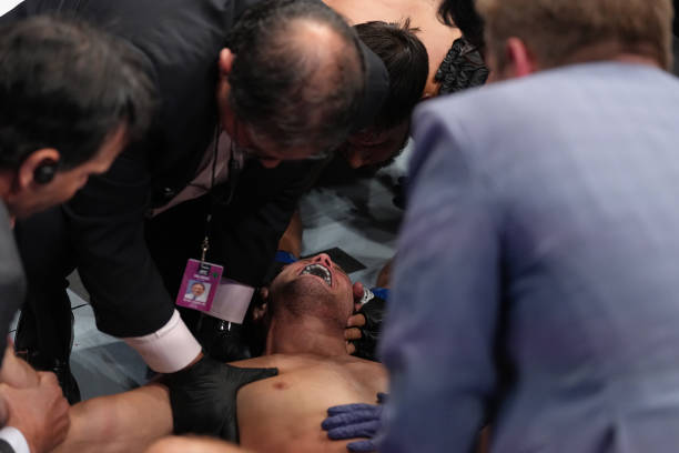 Brian Ortega reacts after suffering an apparent shoulder injury against Yair Rodriguez of Mexico in a featherweight fight during the UFC Fight Night...
